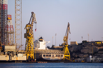 Fototapeta na wymiar Big cranes at the Maltese dry dock found in the Grand Harbour.