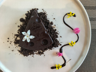 Fototapeta premium Slice of chocolate cake on a white plate with top view sweet food