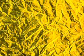 Gold foil texture background, pattern of yellow wrapping paper with crumpled and wavy.
