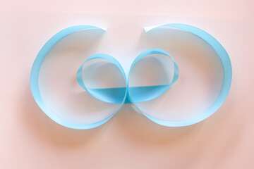 Celebratory blue bow on a white background.
