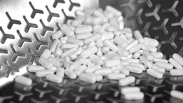 Cinematic footage of Pills, tablets and caplets on a production plant