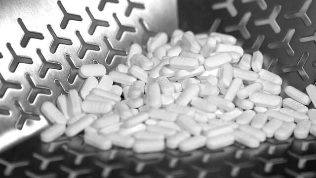Cinematic footage of Pills, tablets and caplets on a production plant