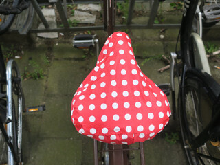 red saddle cover with wite dots on a bicycle in Amsterdam