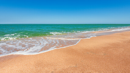 Fototapeta na wymiar Beach with turquoise sea and yellow sand, resort summer background