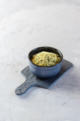 Hemp seeds in a gray bowl on the table. Healthy food, protein.