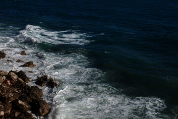 Ocean wave background breaking sea water rocky shore