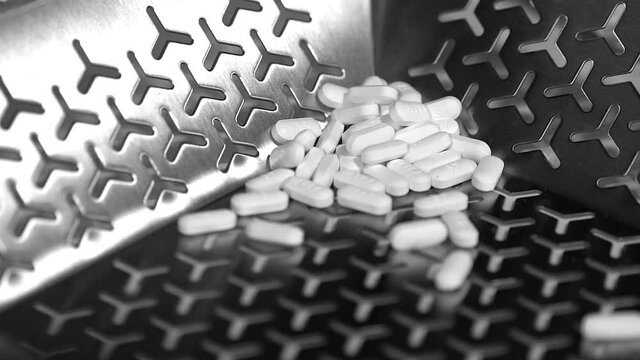 Cinematic footage of Pills, tablets and caplets on a production plant