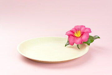 Fototapeta na wymiar Natural disposable plate with pink tropical flower