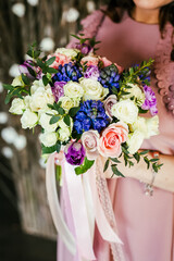 Wedding bouquet of the bride in women's hands. wedding flowers. Bridal bouquet of fresh flowers, wedding concept