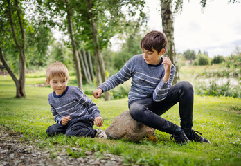 Naklejka na ściany i meble Two angry brothers fighting in park outdoors