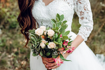 Wedding bouquet of the bride in women's hands. wedding flowers. Bridal bouquet of fresh flowers, wedding concept