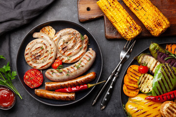 Grilled sausages and vegetables with spices and herbs
