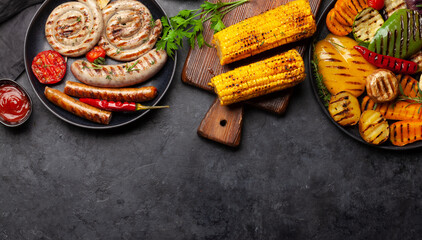 Grilled sausages and vegetables with spices and herbs