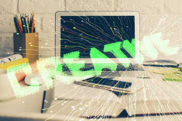 Desktop computer background in office and start up theme hologram drawing. Double exposure. Startup...