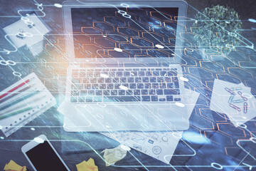 Double exposure of laptop computer and technology theme hologram. Concept of freelance work.