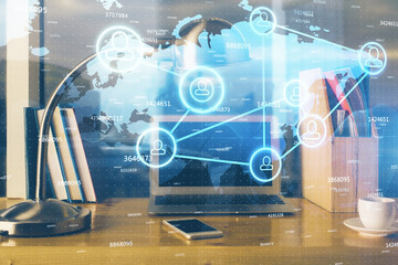 Computer on desktop with social network theme icon. Multi exposure. Concept of international connections.