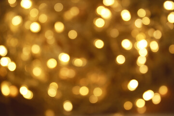 Golden bokeh gold background glitter blur celebration happy new year 2021 2022 christmas bright yellow lights on the dark background