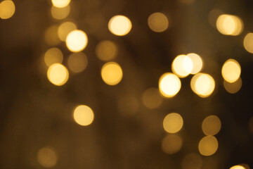 Golden bokeh gold background glitter blur celebration happy new year 2021 2022 christmas bright yellow lights on the dark background