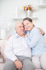 cute elderly couple in light interior.