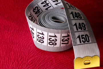 measuring tape on a fabric background