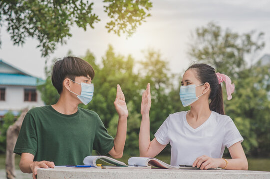 Asian Man And Women Back To School A Wearing Face Mask And Shake Hands Keep New Normal No Touching Social Distancing