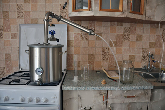 moonshine still in action in the kitchen of a small apartment.