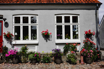 Fototapeta na wymiar Mariager, Denmark An old house with flowers out front.