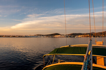 Pink sunrise over the sea and Naoussa coastal village (Paros Island), landscape view from sailing...