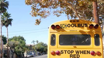 Yellow iconic school bus in Los Angeles, California USA. Classic truck for students back view....