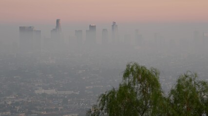 Highrise skyscrapers of metropolis in smog, Los Angeles, California USA. Air toxic pollution and...