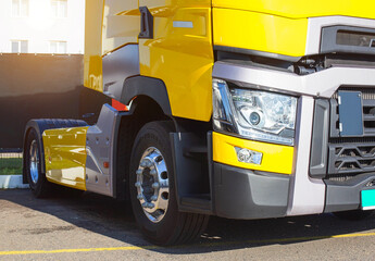 Yellow modern semi-trailer truck with modern LED headlights. Stylish and beautiful truck concept, logistic