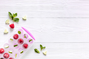 Ice cubes with berries and mint top view copy space