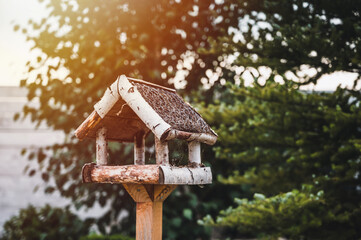 Little Birdhouse by tree in the garden