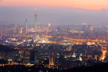 Fototapeta na wymiar Panoramic aerial view of crowded Taipei City, Taipei landmark, XinYi Commercial District, Keelung River and downtown area at moody dusk ~ Taipei City skyline in evening twilight