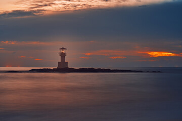 Seascape at sunset. Lighthouse on the coast. long shutter shot