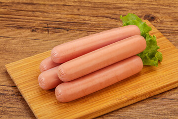 Tasty meat sausages over board