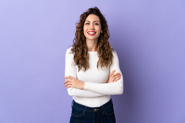 Young caucasian woman isolated on purple background keeping the arms crossed in frontal position
