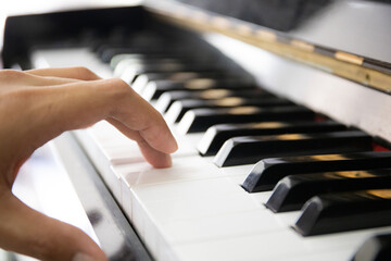 Close up of someone playing piano by finger