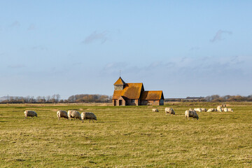 The 12th century Church of Thomas A Becket a former Archbishop of Canterbury. Rural church in Fairfield on Romney Marsh. - obrazy, fototapety, plakaty