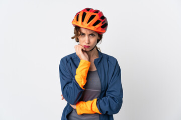 Young cyclist woman isolated on white background having doubts