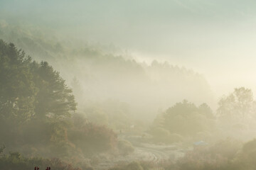 Beautiful misty morning dream valley mountain autumn fogy and clouds.