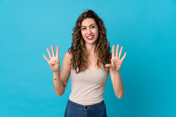 Young caucasian woman isolated on blue background counting nine with fingers