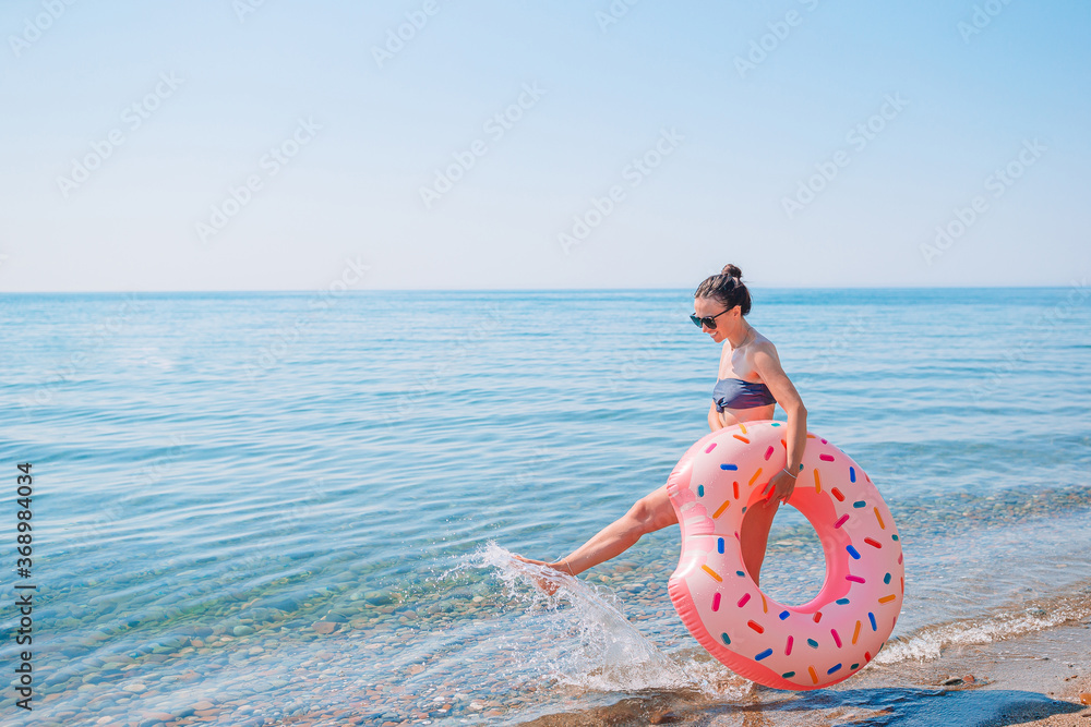 Wall mural young woman in hat on the beach vacation