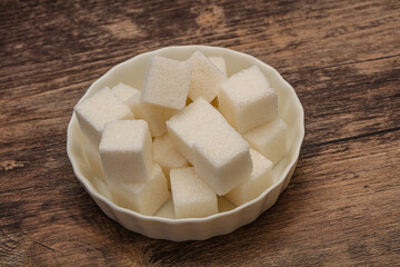 Refined white sugar cubs in the bowl