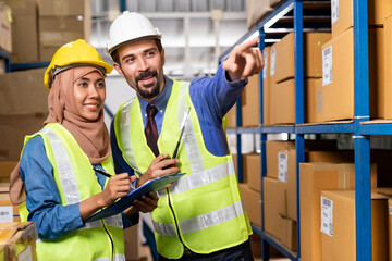 Warehouse manager and muslim worker working inventory