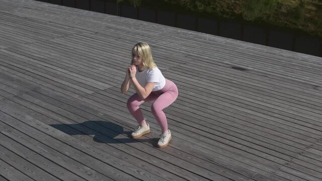 Circuit training outdoor exercise, bootcamp workout ideas. Young woman do quick at-home gym resistance fitness course. High-intense aerobics exercises build the perfect body &ndash; wellness and healthcare.