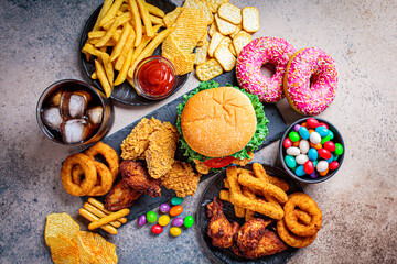 Fast food assortment. Junk food concept. Unhealthy food for the heart, teeth, skin, figure.