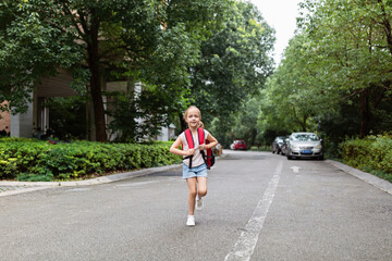 School child after end coronavirus pandemic outbreak. Blonde girl going back to school after covid-19 quarantine and lockdown. Happy kid outdoor. New normal