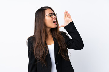 Young Brazilian girl with blazer over isolated white background shouting with mouth wide open