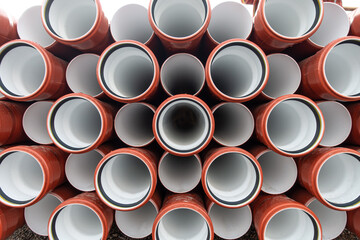 background of colorful big plastic pipes used at the building site.